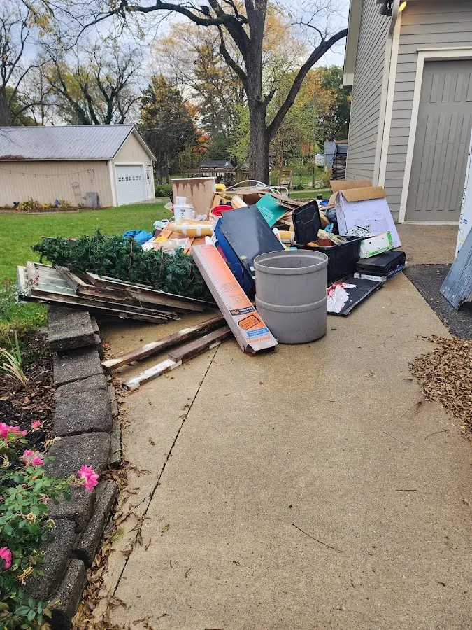 Dumpster being loaded with debris for 12 Yard Dumpster Rental in Fort Mill